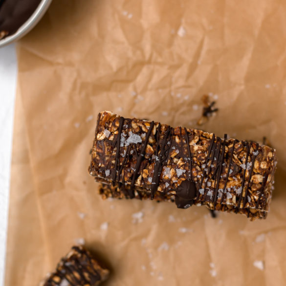 almond date oat bars drizzled with chocolate