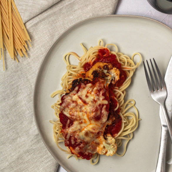 cauliflower parm over a bed of spaghetti and extra sauce