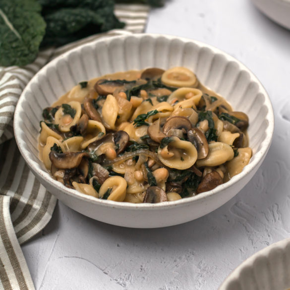 a large bowl of orecchiette with kale and white beans