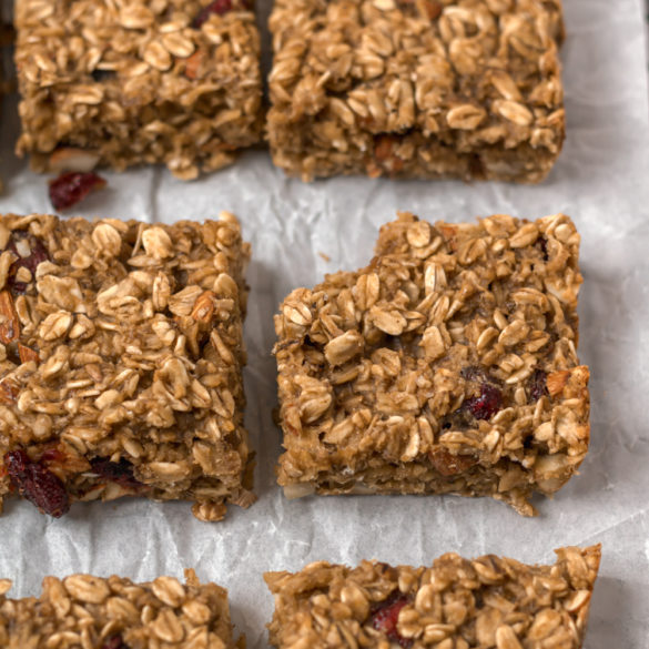 Baked oatmeal squares cut and one with a bite out of it