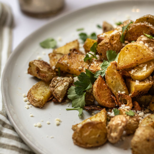 a plate of Mexican brunch potatoes with cotija and cilantro