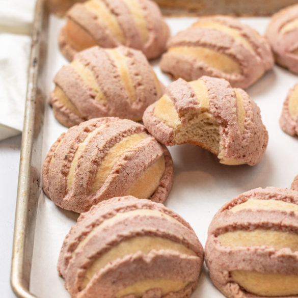 a tray full of strawberry conchas