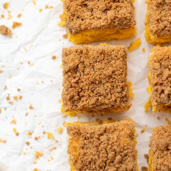 pumpkin coffee cake squares on a sheet of parchment paper